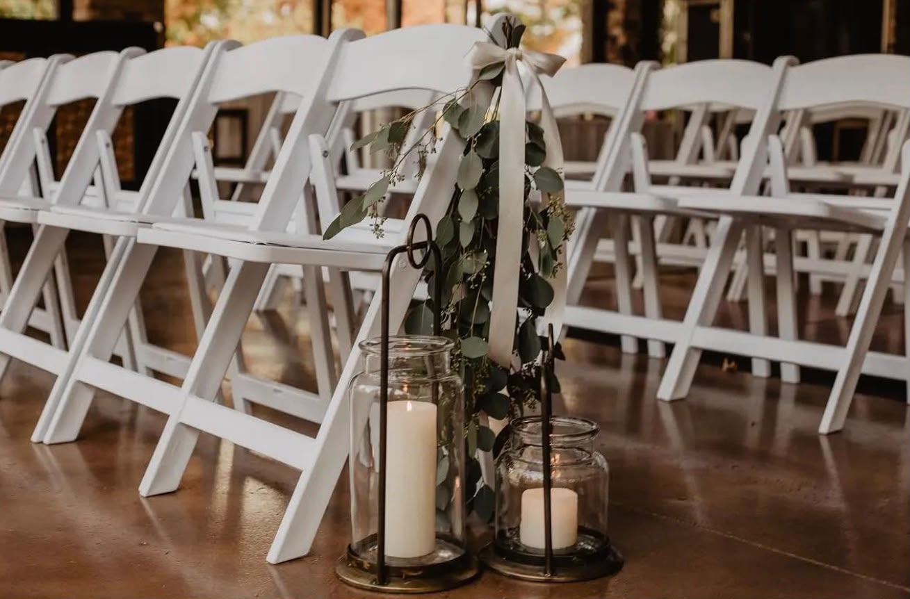 White folding chairs lined up for a ceremony